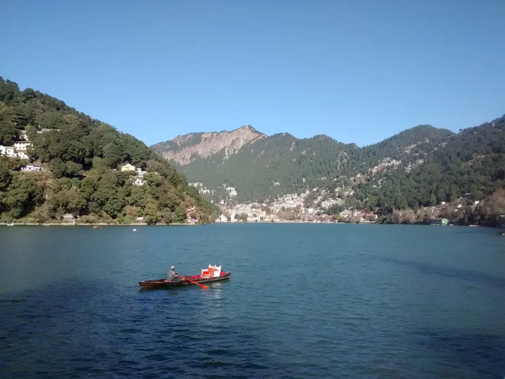 Naini Lake in Nainital surrounded by hills at sunrise
