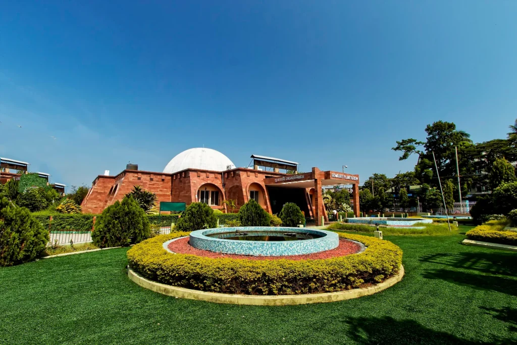 Guwahati Planetarium, one of the top Places to Visit in Guwahati, featuring a modern dome and lush green surroundings.